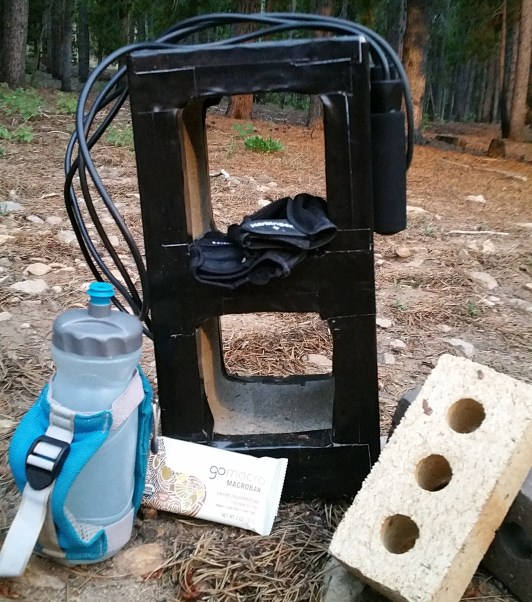 Water bottle, snack, jump rope, bricks, and a cinder block wrapped in duct tape
